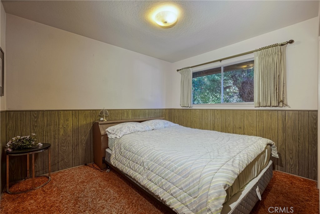 7783 Cora Drive Lucerne, CA 95458 - Photo 17 of 41 a bed sitting in a bedroom next to a window