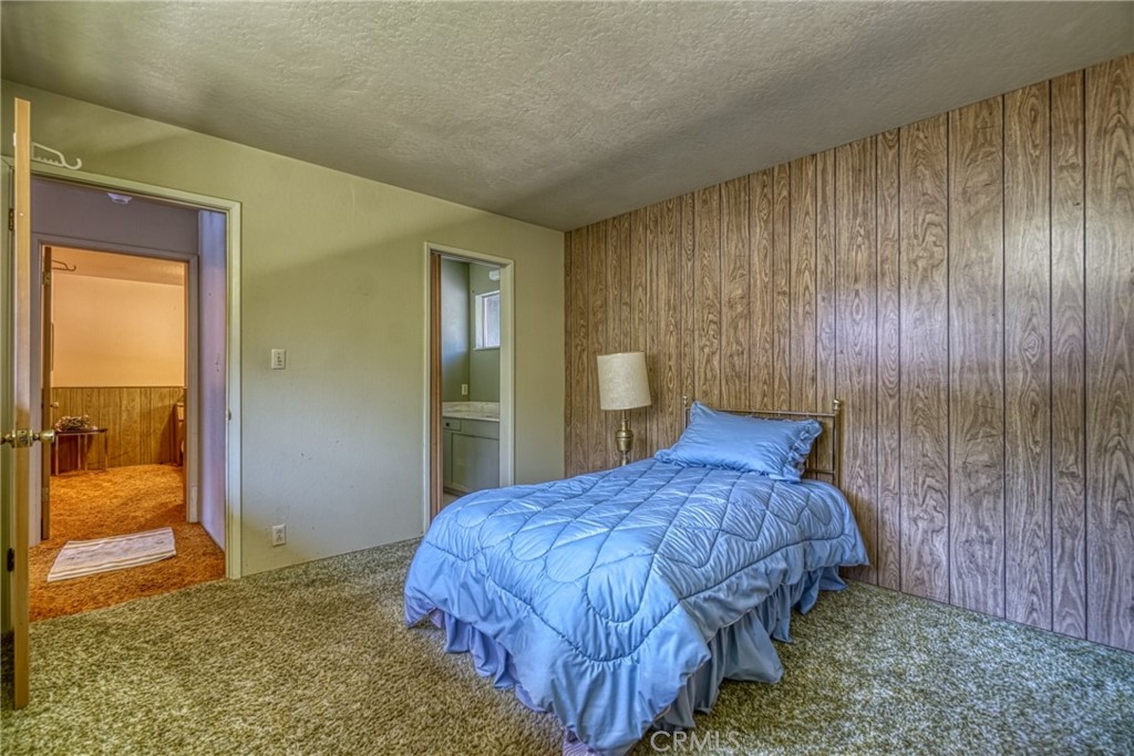7783 Cora Drive Lucerne, CA 95458 - Photo 21 of 41 a bedroom with a bed and a cabinets