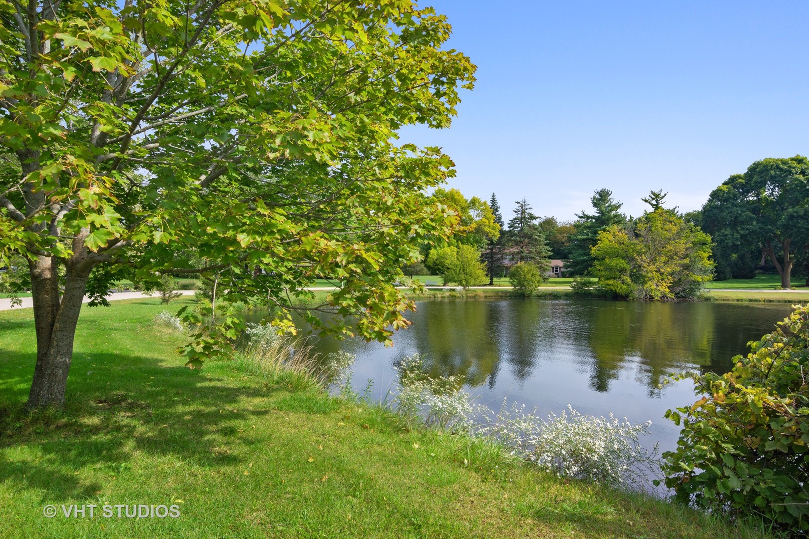 128 Colony Drive Inverness, IL 60010 - Photo 22 of 22 a view of a lake with a house in the background