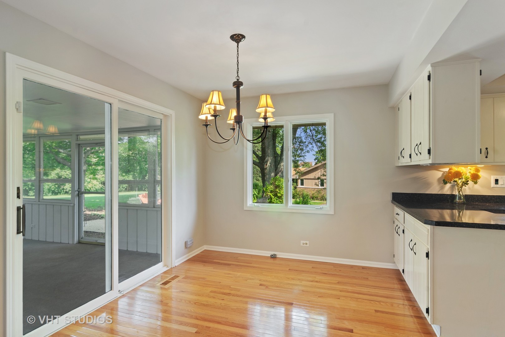 128 Colony Drive Inverness, IL 60010 - Photo 7 of 22 a kitchen that has a lot of windows and chandelier