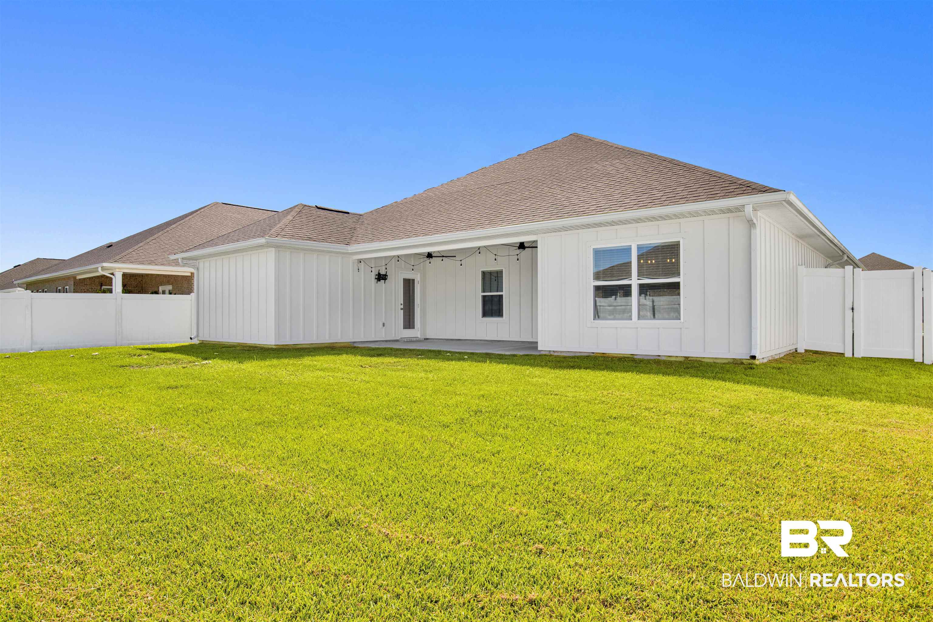 11602 Genuine Risk Circle Daphne, AL 36526 - Photo 26 of 30 Rear view of house with ceiling fan, a fenced backyard, a patio area, roof with shingles, and board and batten siding