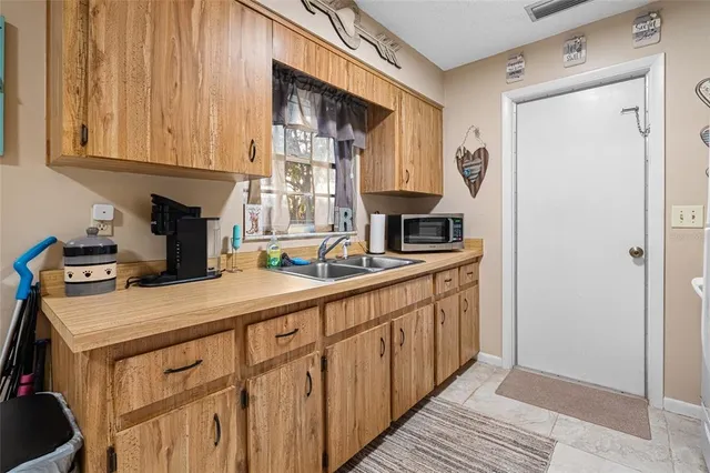 a kitchen with stainless steel appliances a sink stove and cabinets