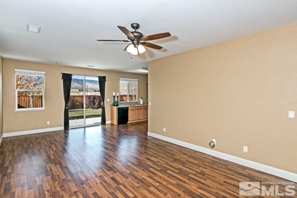 11525 Rivolli Court Reno, NV 89521 - Photo 6 of 20 a view of an empty room with window and wooden floor