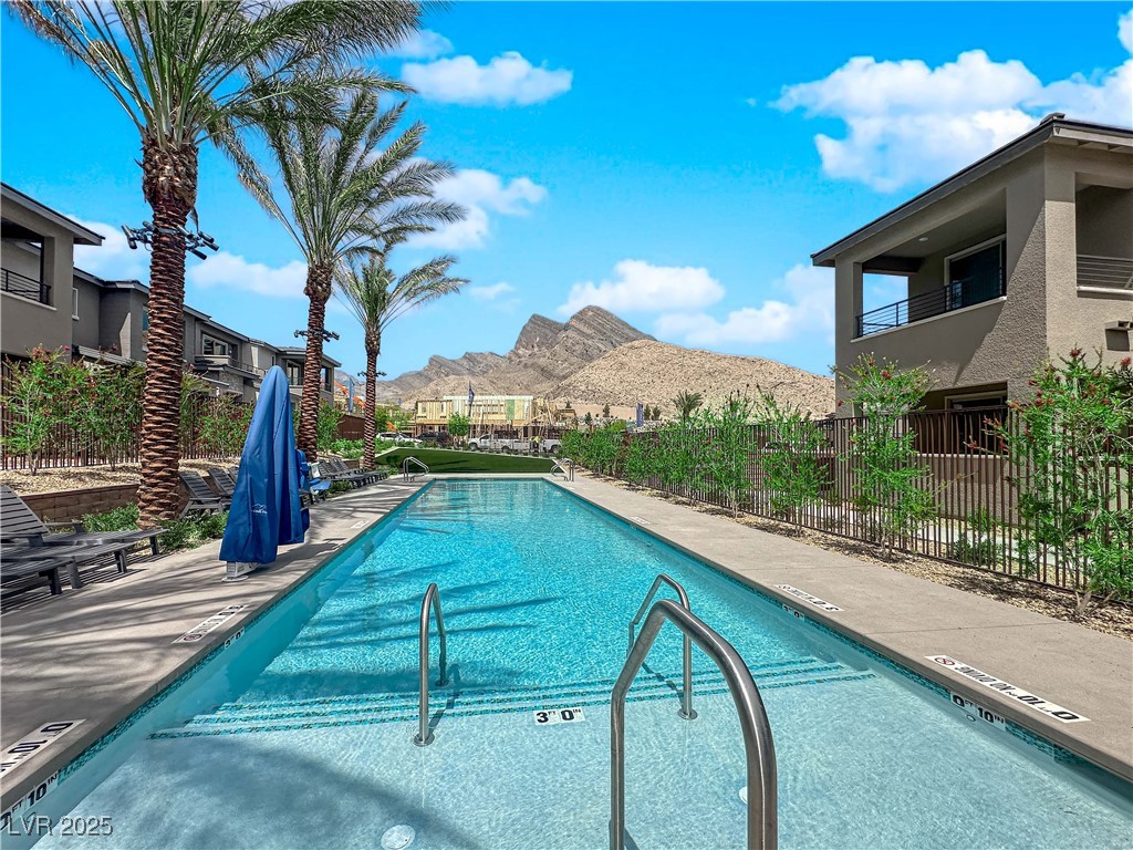 2467 Altitude Street Las Vegas, NV 89138 - Photo 3 of 7 Community pool featuring a mountain view and a patio