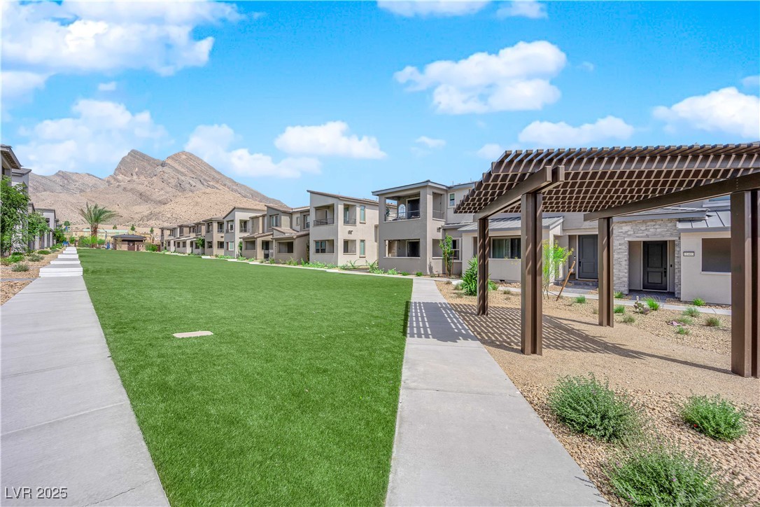 2467 Altitude Street Las Vegas, NV 89138 - Photo 5 of 7 View of home's community featuring a yard, a residential view, and a pergola