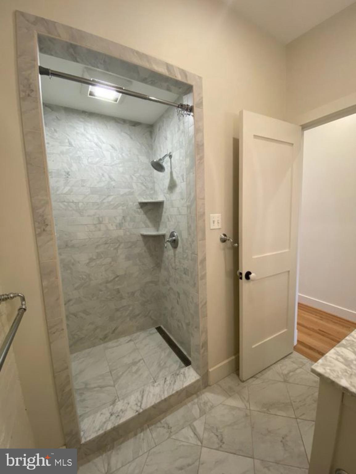 19 Branch Lane East Baltimore, MD 21202 - Photo 8 of 13 a bathroom with a shower and a glass door