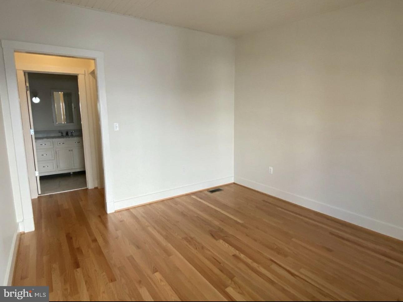 19 Branch Lane East Baltimore, MD 21202 - Photo 10 of 13 a view of an empty room and wooden floor