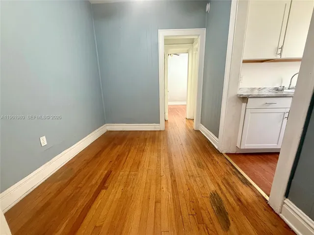a view of a room with wooden floor and staircase