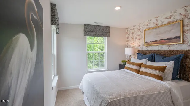 a bedroom with a bed and a painting on the wall