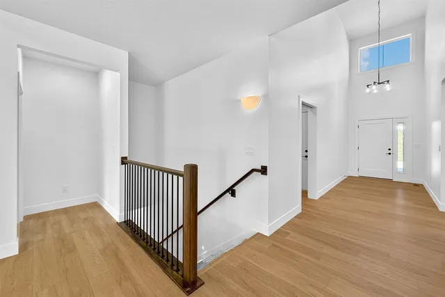 a view of hallway with wooden floor