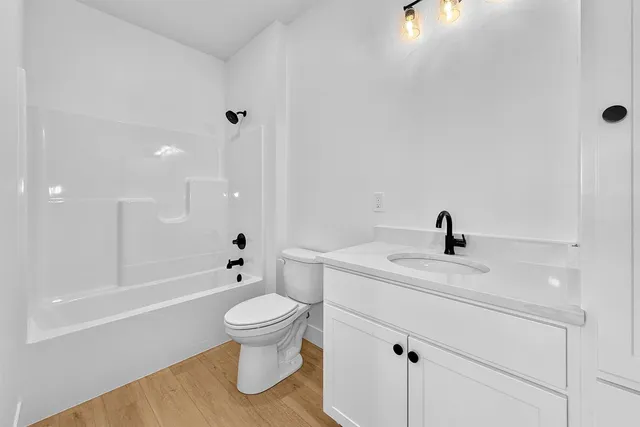 a bathroom with a sink a toilet and a large mirror