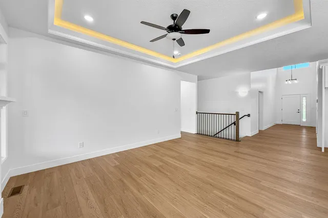 a view of an empty room with a ceiling fan