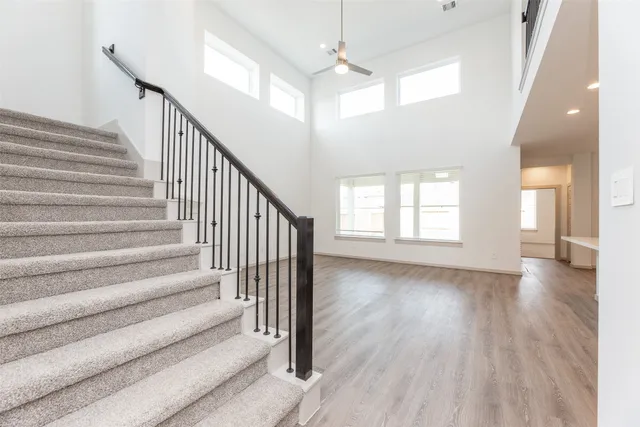 a view of a room with wooden floor and stairs