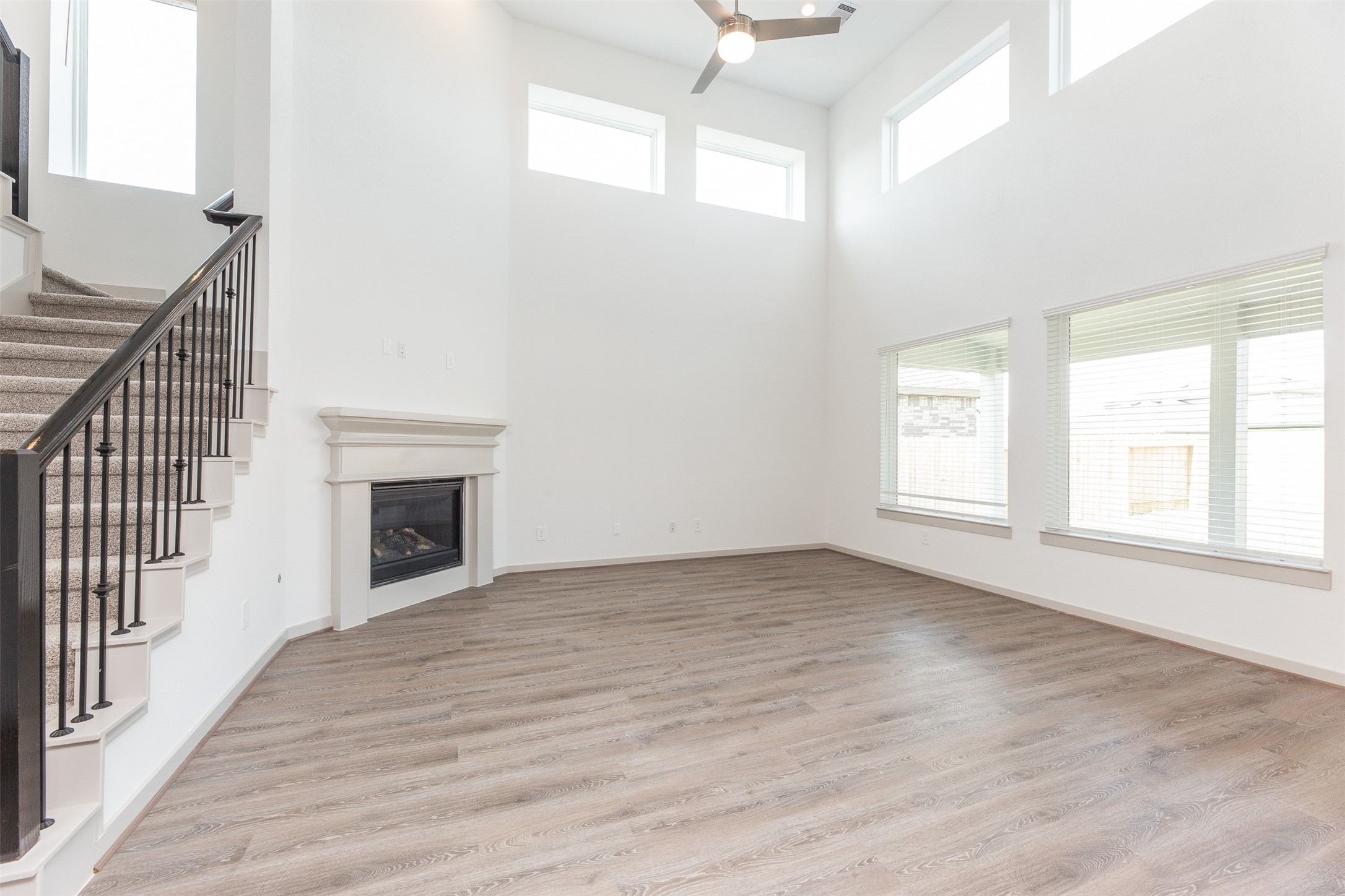29502 Red Rocks Pk Drive Katy, TX 77494 - Photo 5 of 17 an empty room with wooden floor fireplace and windows