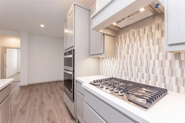 a kitchen with kitchen island granite countertop a stove and a refrigerator