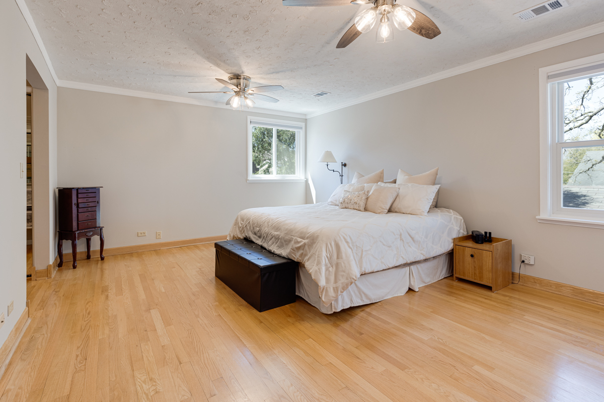 102 Harding Avenue Fox River Grove, IL 60021 - Photo 16 of 29 a bedroom with a bed and a chandelier