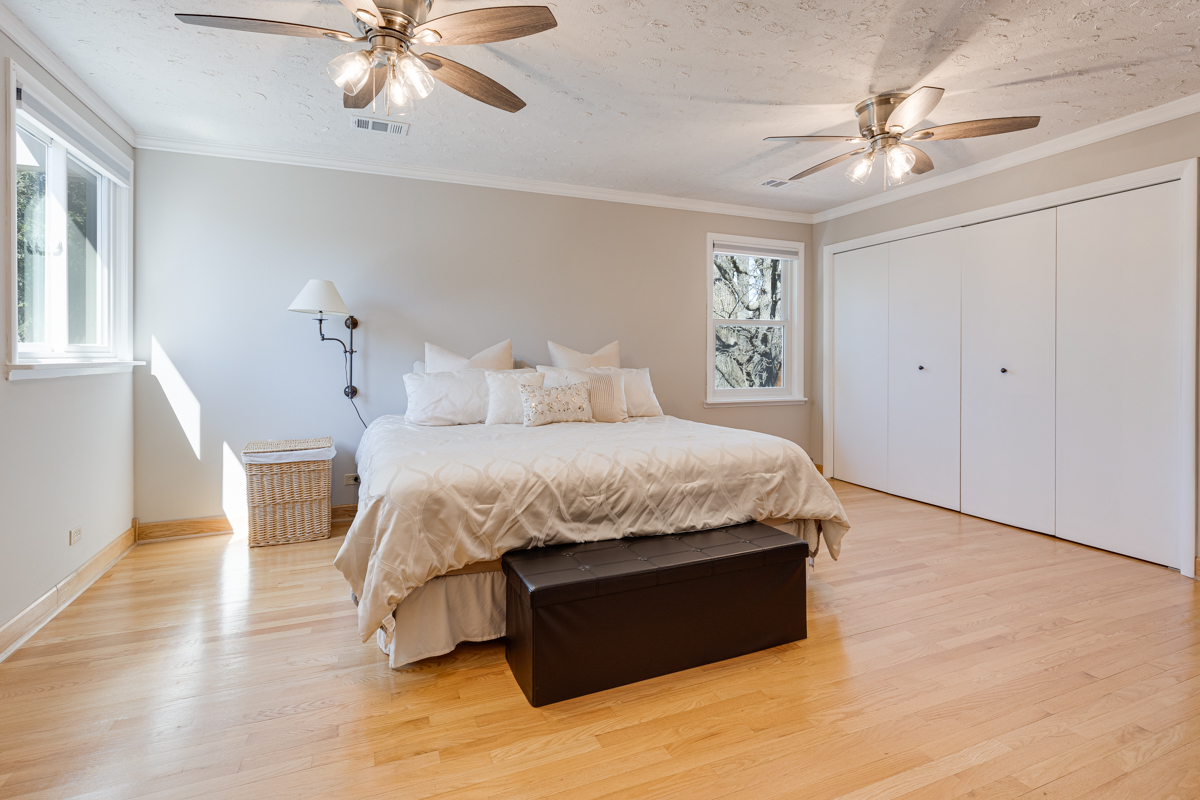 102 Harding Avenue Fox River Grove, IL 60021 - Photo 17 of 29 a spacious bedroom with a bed and a chandelier