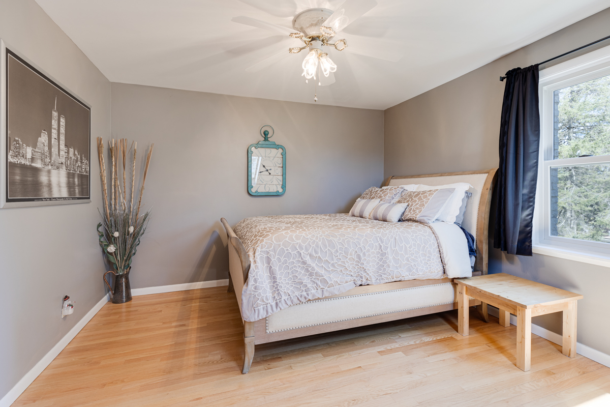 102 Harding Avenue Fox River Grove, IL 60021 - Photo 22 of 29 a bedroom with a bed and a chandelier