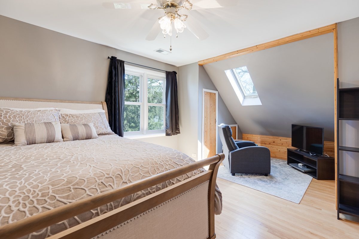 102 Harding Avenue Fox River Grove, IL 60021 - Photo 23 of 29 a bedroom with a large bed and a chandelier