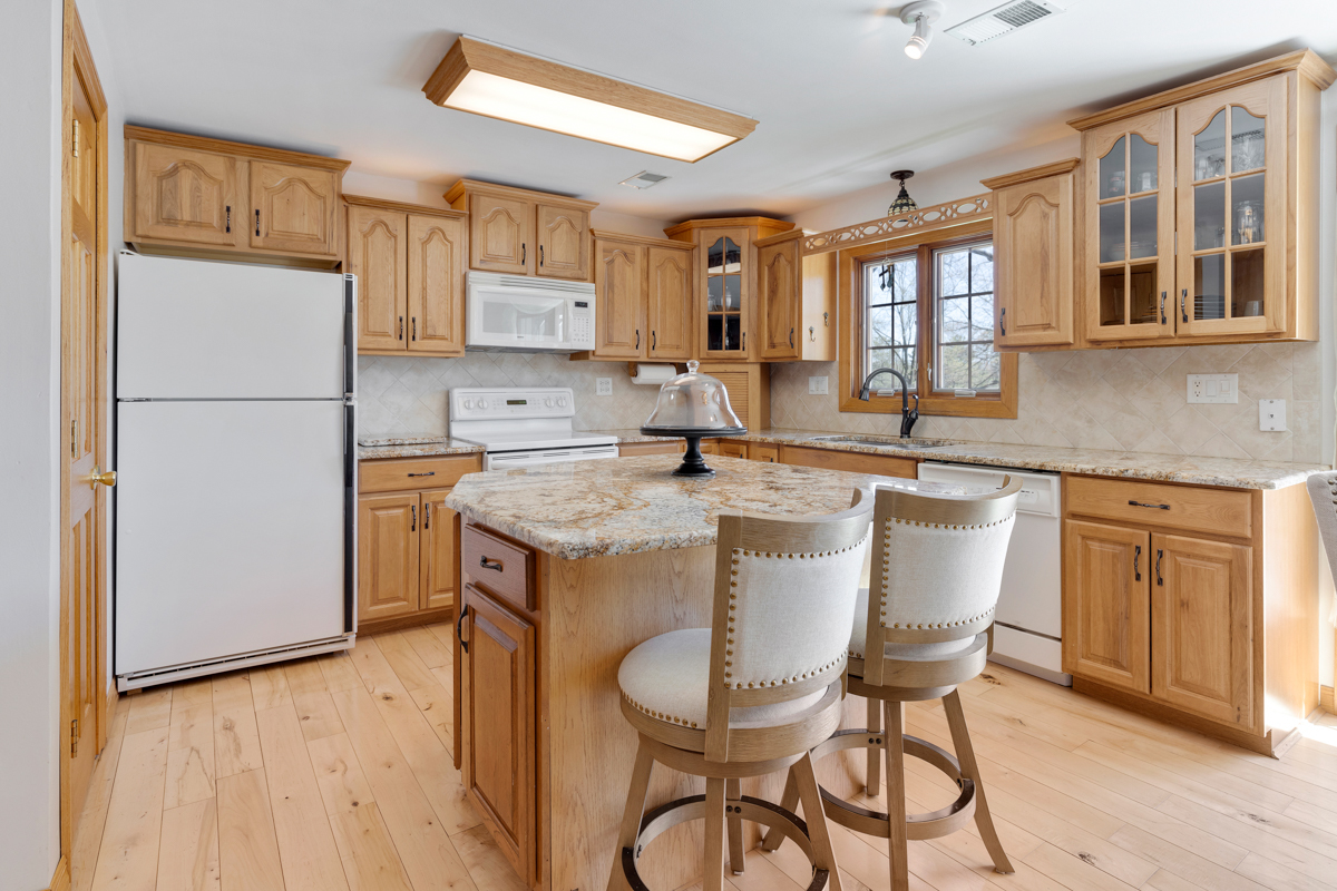 102 Harding Avenue Fox River Grove, IL 60021 - Photo 9 of 29 a kitchen with stainless steel appliances granite countertop a dining table chairs refrigerator and sink