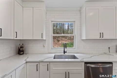 a kitchen with a sink cabinets and window
