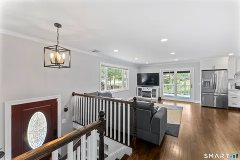 a view of a living room and dining room with wooden floor