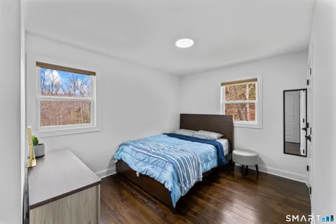 a bedroom with a bed and a desk