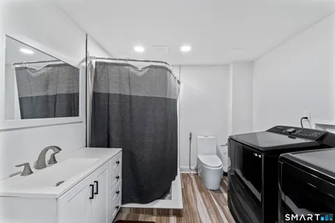 a utility room with two washing machine
