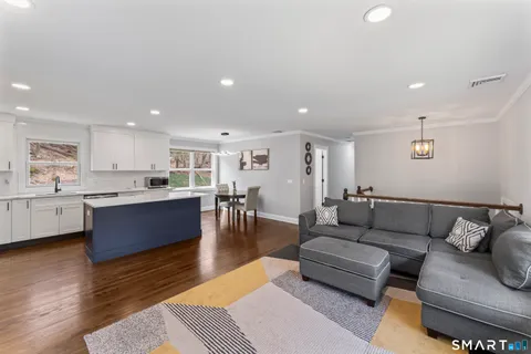 a living room with furniture and kitchen view