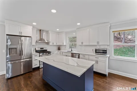 a kitchen with a refrigerator stove a sink and a microwave