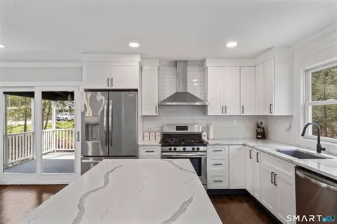 a kitchen with stainless steel appliances a refrigerator sink and cabinets