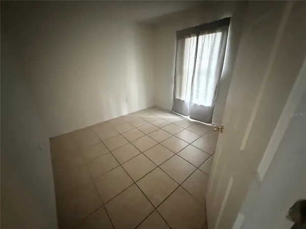 a view of an empty room and a window