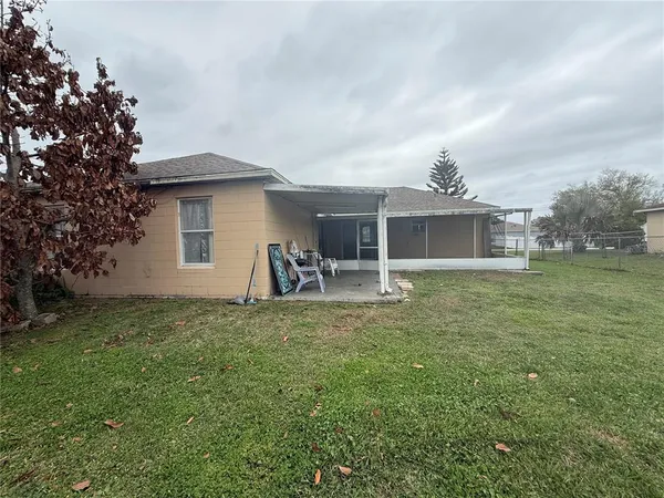 a view of a house with yard and sitting area