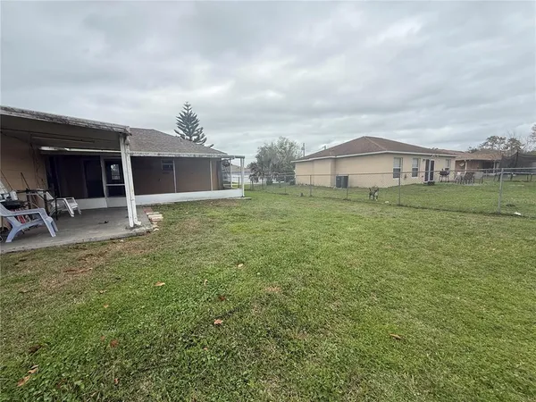a front view of house with yard and trees in the background