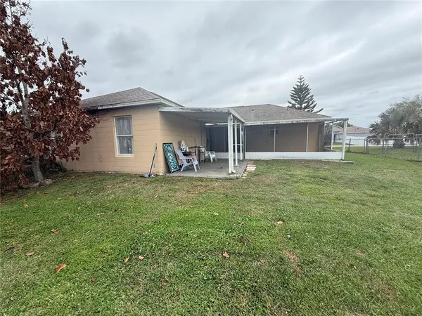 a view of a house with a backyard