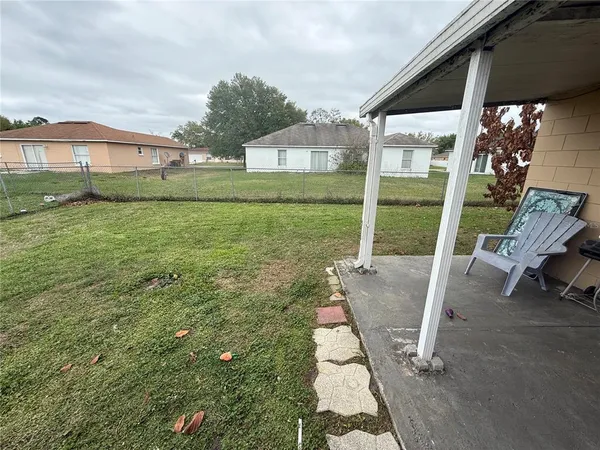 a view of a house with backyard porch and sitting area