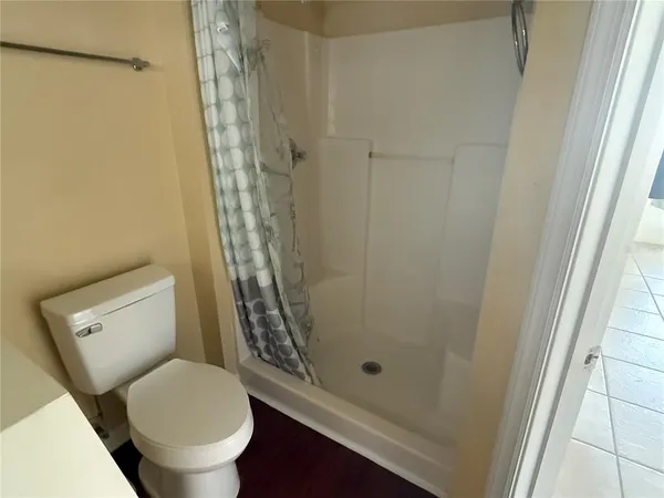 a bathroom with a toilet and a shower