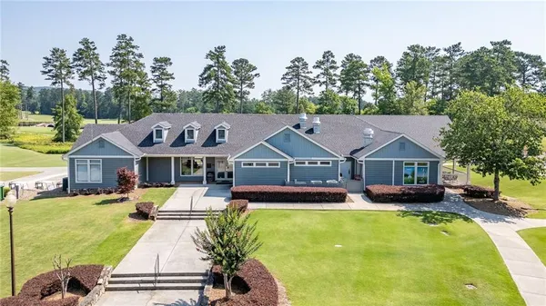 an aerial view of a house with swimming pool garden and patio