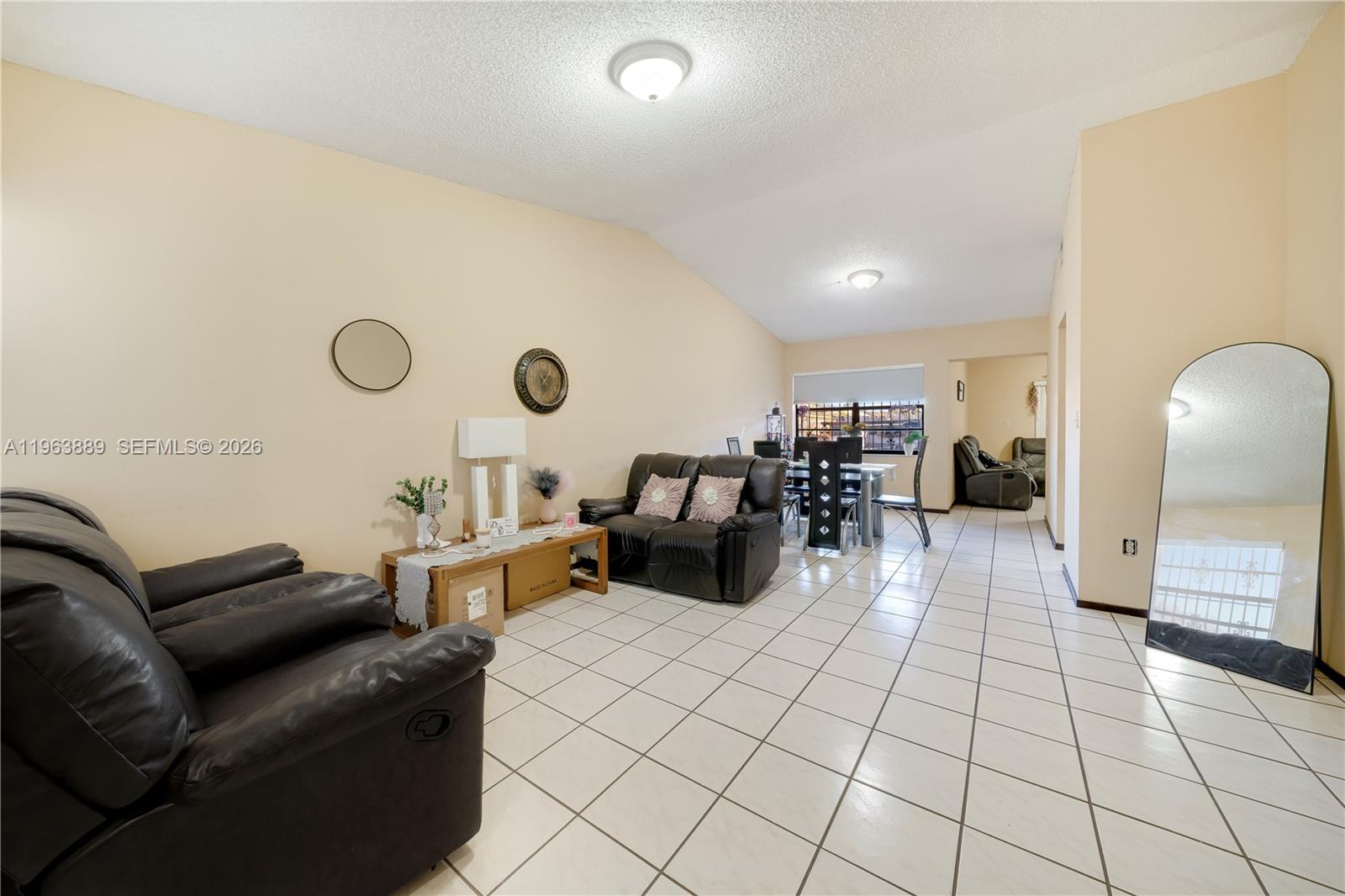 a living room with furniture and a mirror