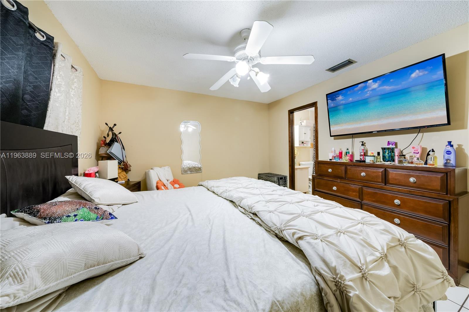 4531 Southwest 144th Avenue Miami, FL 33175 - Photo 12 of 24 a bedroom with a bed and a flat screen tv