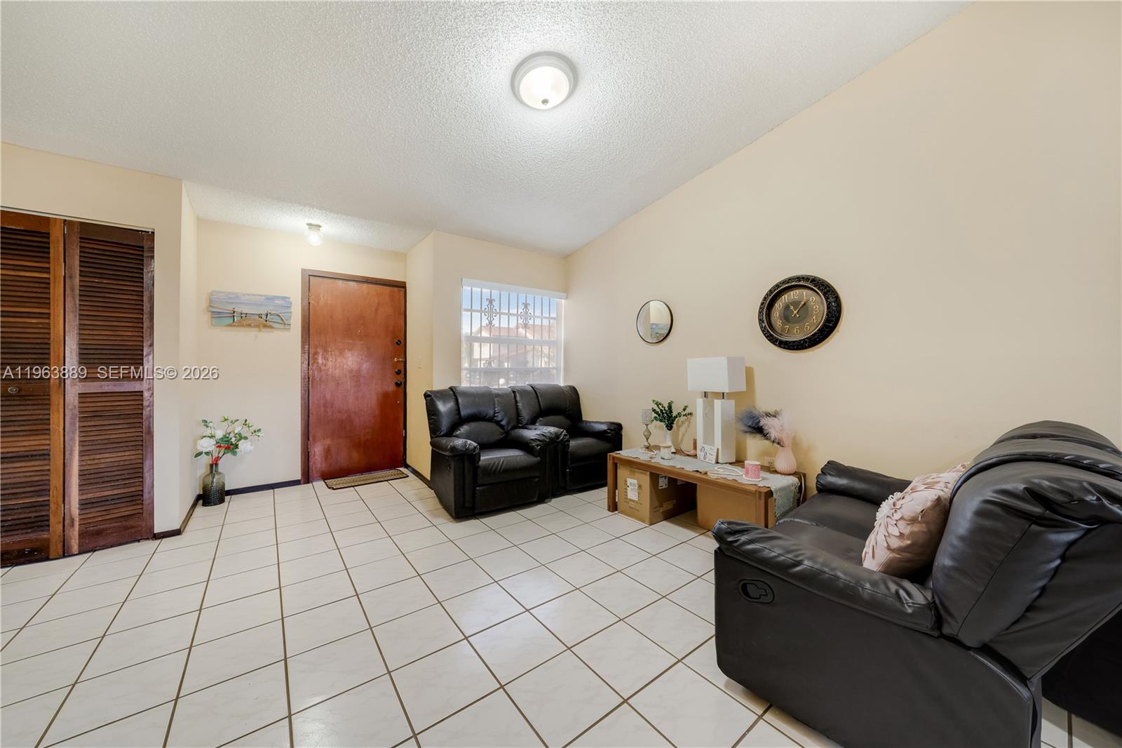 4531 Southwest 144th Avenue Miami, FL 33175 - Photo 2 of 24 a living room with couches and painted walls with a large mirror
