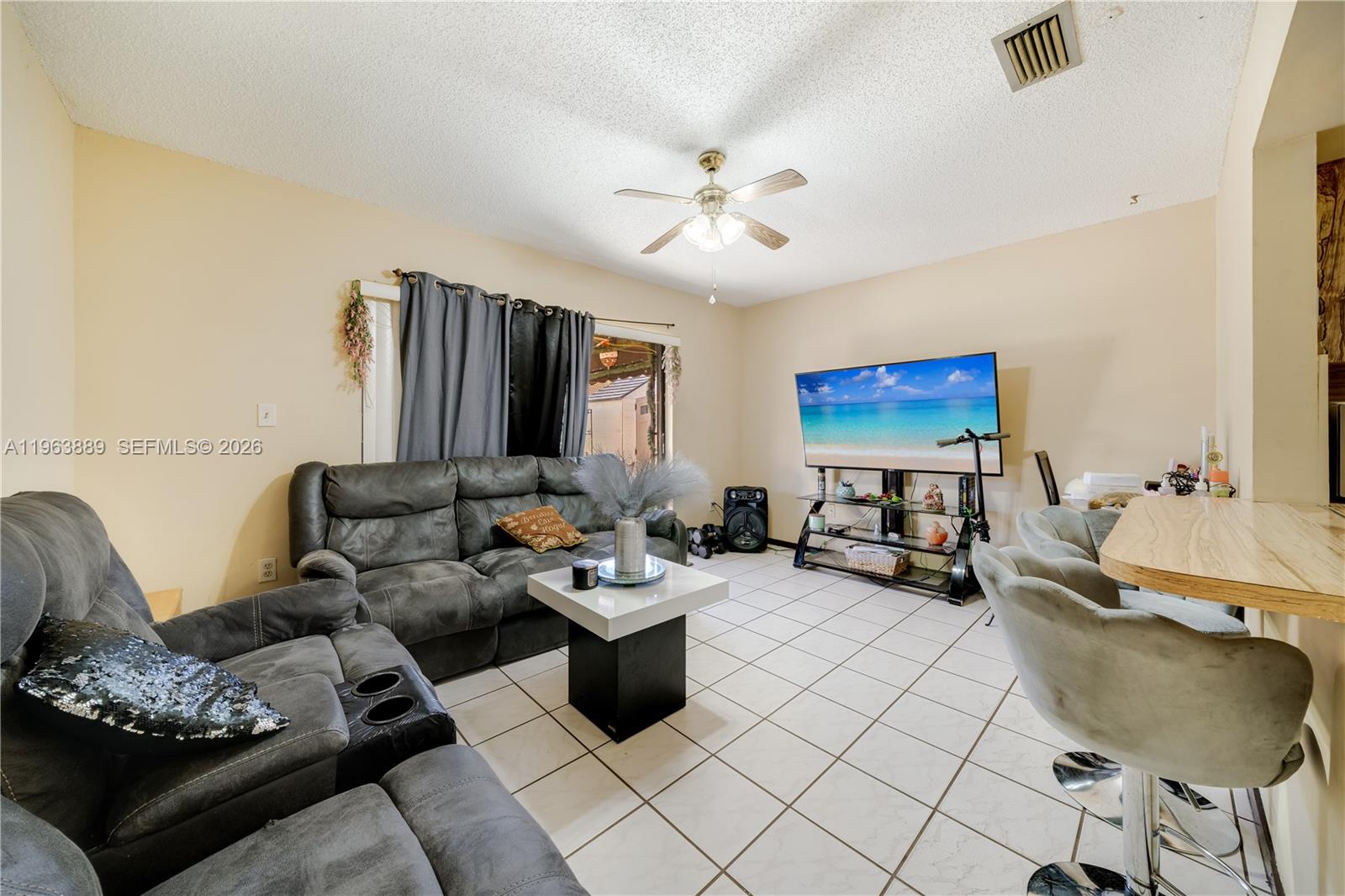 4531 Southwest 144th Avenue Miami, FL 33175 - Photo 3 of 24 a living room with furniture and a flat screen tv