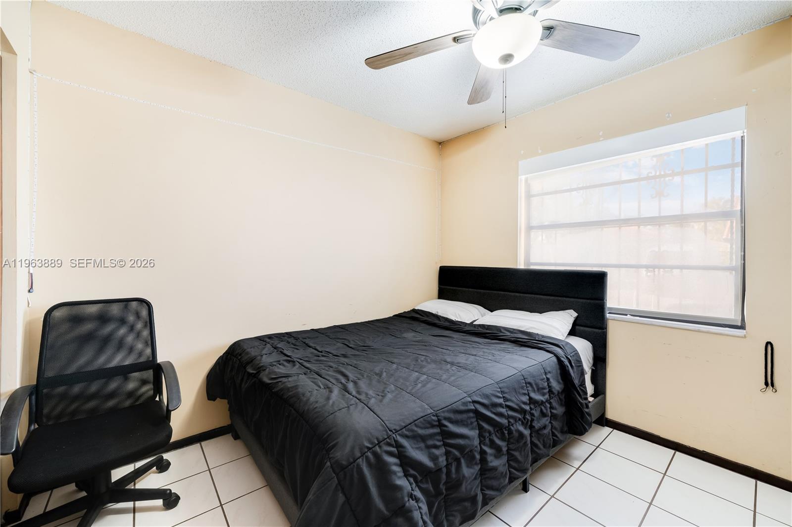 4531 Southwest 144th Avenue Miami, FL 33175 - Photo 9 of 24 a bedroom with a bed and a chair