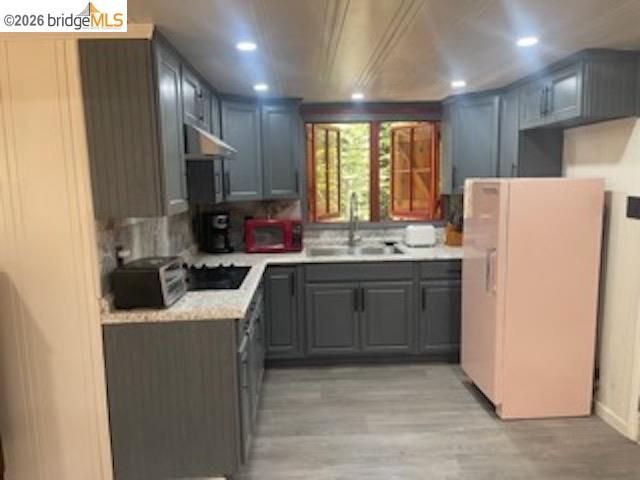 26591 Snow Bowl Road Long Barn, CA 95335 - Photo 16 of 38 a kitchen with refrigerator a sink a stove a microwave a counter top and cabinets