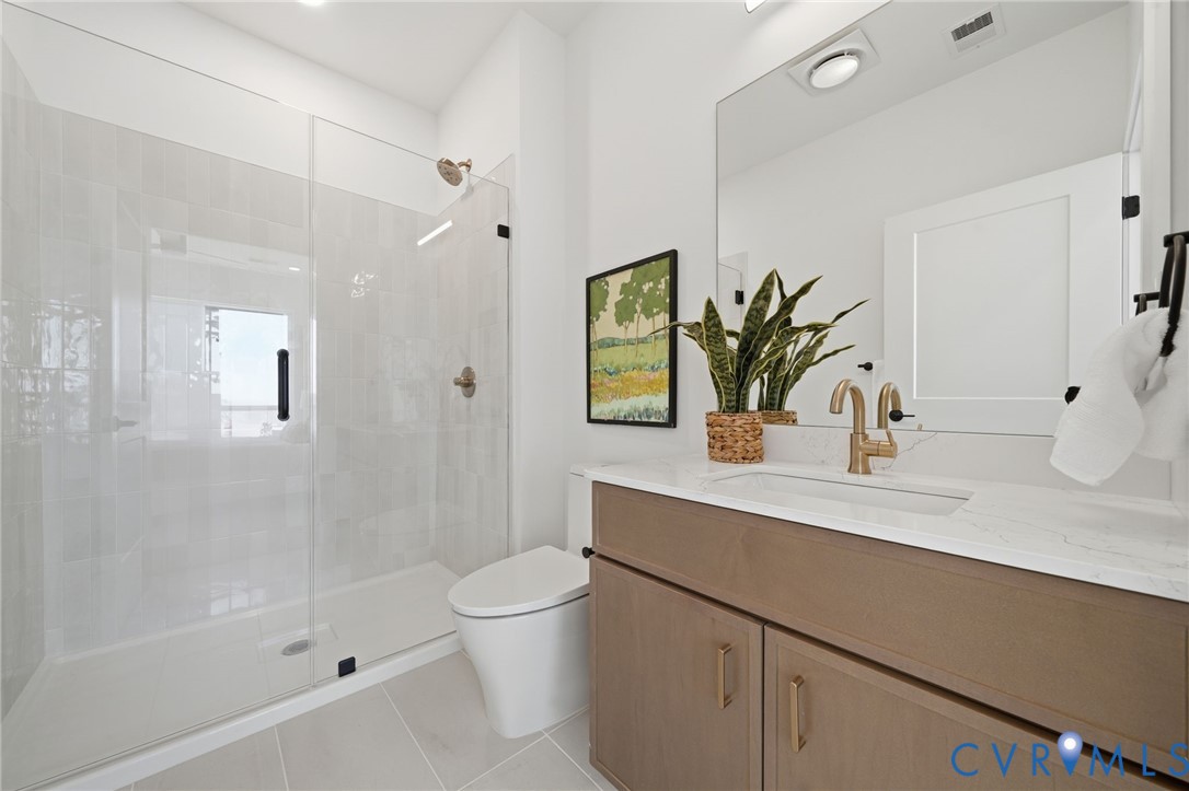 112 Manchester Road Richmond, VA 23224 - Photo 12 of 21 Bathroom featuring a glass-enclosed shower, a mode