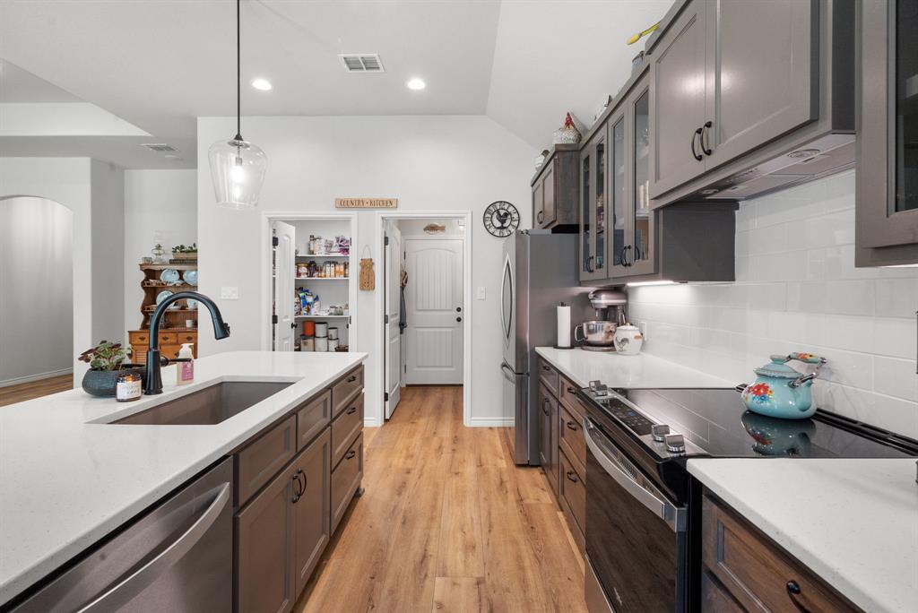 355 Sunset Cove Bluff Dale, TX 76433 - Photo 14 of 40 a kitchen with stainless steel appliances a sink stove and refrigerator
