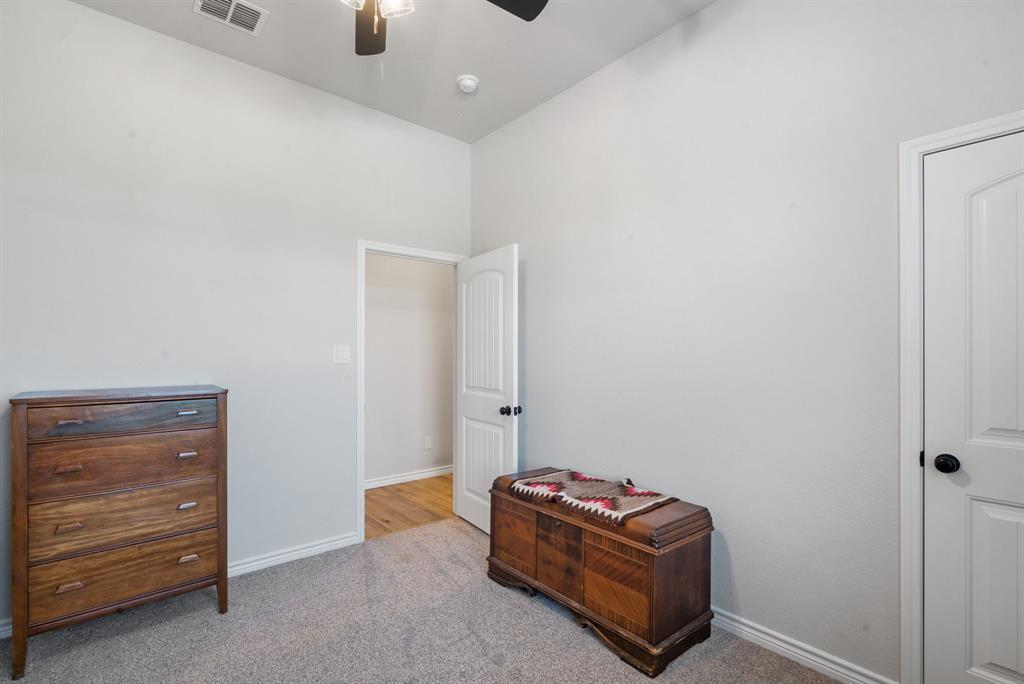 355 Sunset Cove Bluff Dale, TX 76433 - Photo 19 of 40 a room with a cabinet and a lamp