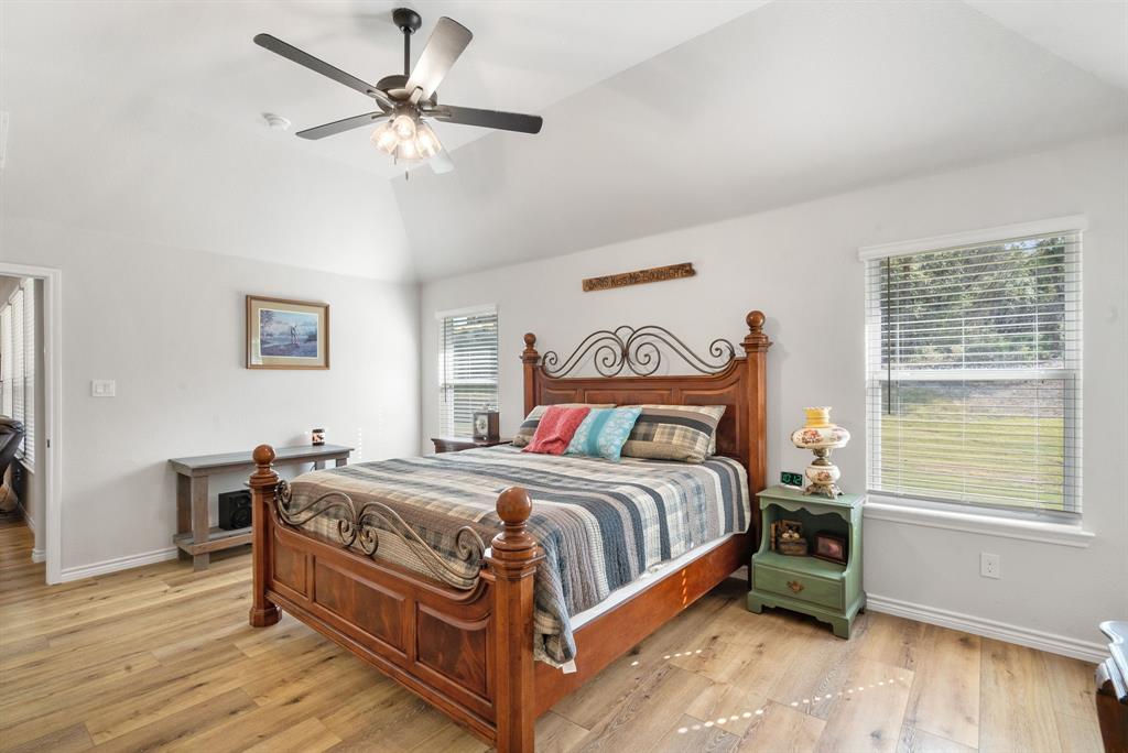 355 Sunset Cove Bluff Dale, TX 76433 - Photo 27 of 40 a bedroom with a bed and a chandelier