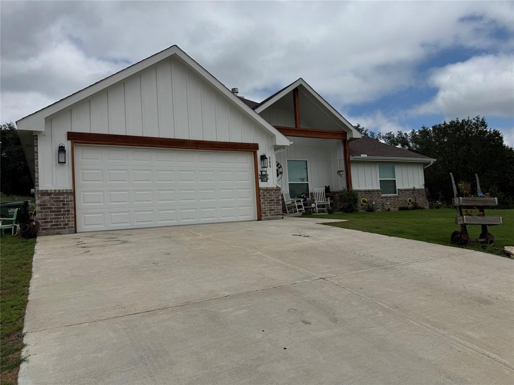 355 Sunset Cove Bluff Dale, TX 76433 - Photo 3 of 40 a front view of a house with a yard and garage