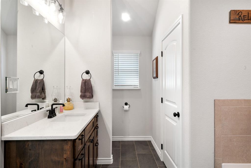 355 Sunset Cove Bluff Dale, TX 76433 - Photo 31 of 40 a bathroom with a sink vanity and a mirror